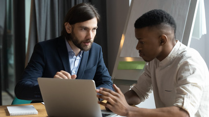 Businessman mentor training African American intern, giving instructions