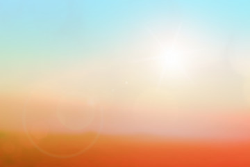 Natural background blurring warm colors and bright sun light. Bokeh or Christmas background Green Energy at sky sunny color orange light patterns plain abstract flare evening clouds blur.