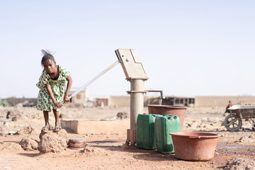 Cute African Infant Taking Pure Water in an arid zone