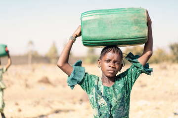 Real Aboriginal Woman getting Healthy Water for a lack of water symbol