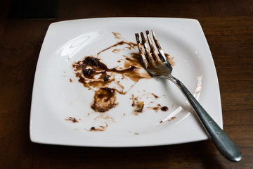 dirty and empty dishes on wooden table.