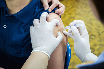 nurses' s hands are vaccinations to patients using the syringe