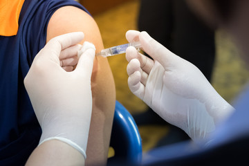nurses' s hands are vaccinations to patients using the syringe