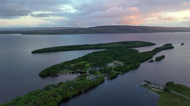 Lusty Beg Island during colorful sunset in Northern Ireland, backwards aerial