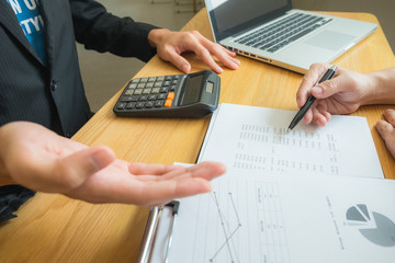 Bank employees sit and work and check the financial summary..Working in an office, a consultancy and a summary.