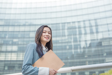 Fototapeta premium Young business lady with document bag