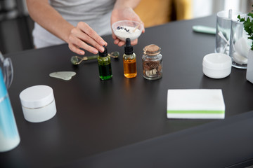 Young woman making face mask at home