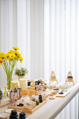 Workshop table with handmade soap bars and dry herbs and other ingredients