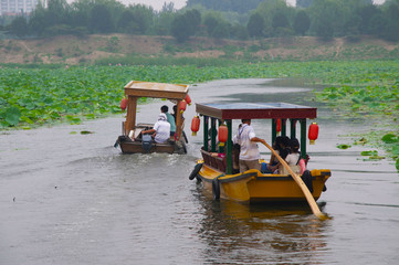 Fototapeta na wymiar Tourists taking a tour on boats in Beijing, China.