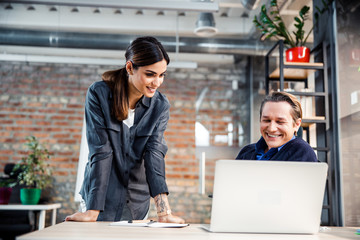 Positive delighted businessman laughing at funny joke