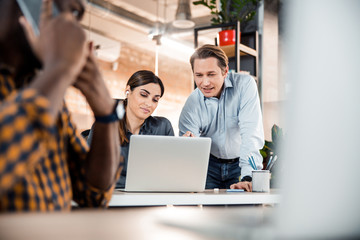 Busy international worker sitting on the foreground