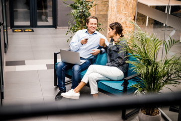 Handsome middle aged man talking to his colleague