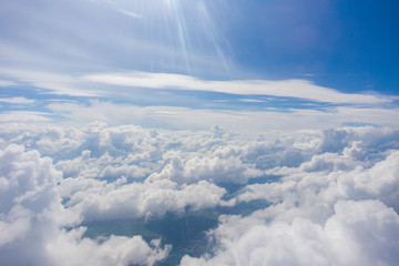 View from the porthole of an airplane. A beautiful view of the white clouds from a height of 10,000 meters.