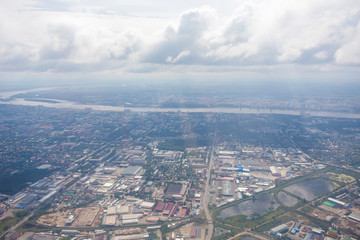 View from above. The border city of Blagoveshchensk from an airplane window. A bridge over the Amur River, connecting Russia and China.