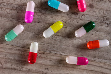 Colorful pill capsules on table close up