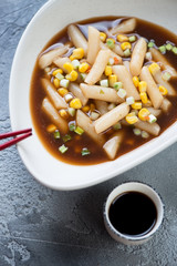 Close-up of korean black soybean sauce topokki in a bowl, vertical shot, high angle view
