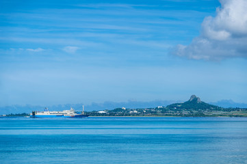 Fototapeta na wymiar 備瀬海岸から望む伊江島とフェリー -Okinawa blue sea-