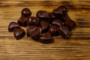 Tasty chocolate candies on wooden table