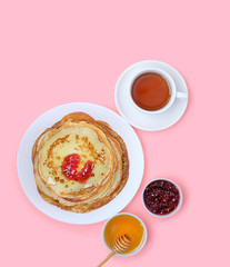 Pancake week, Maslenitsa holiday concept. packages Cup of tea, honey and jam on pink background. Breakfast with Homemade Pancakes. flat lay