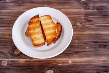 Background with slices of toast bread and old wooden table.