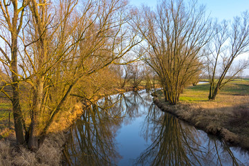 Fototapeta na wymiar The river Locknitz near Wittenberge, Brandenburg. It is a nice quiet atmosphere in the warm light