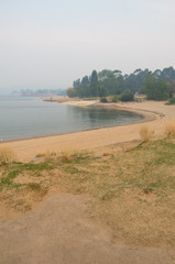 Lake Jindabyne covered in a smokey haze