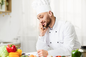 Cook Man Talking On Phone Receiving Order Standing Indoor