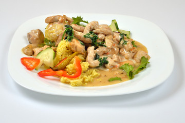 Food from a chicken restaurant with vegetables and sauce.