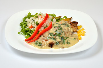 Food from a chicken restaurant with vegetables and sauce.