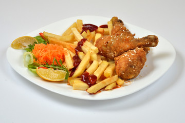 Food from a chicken restaurant with vegetables and sauce.