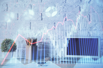 Financial graph colorful drawing and table with computer on background. Double exposure. Concept of international markets.