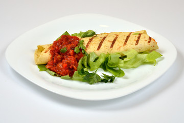 Food from a chicken restaurant with vegetables and sauce.