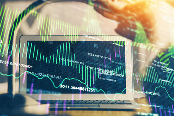 Financial graph colorful drawing and table with computer on background. Double exposure. Concept of international markets.