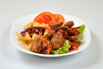 Food from a chicken restaurant with vegetables and sauce.