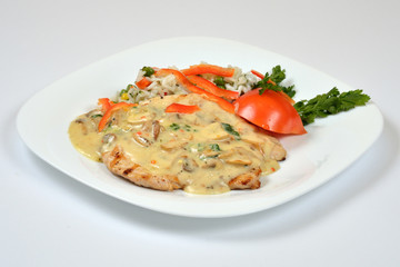 Food from a chicken restaurant with vegetables and sauce.
