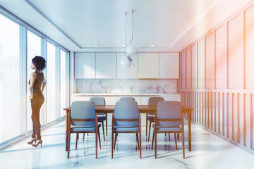 African woman in white and blue kitchen