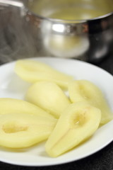 Cooked pear halves on plate. Making Chocolate, Pear and Pecan Pie Series.