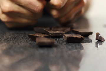 Breaking chocolate bar on pieces. Making Chocolate, Pear and Pecan Pie Series.