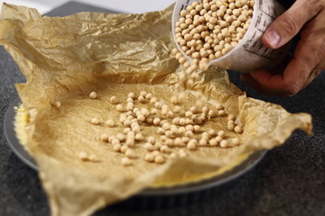 Adding baking beans in pastry case. Making Chocolate, Pear and Pecan Pie Series.