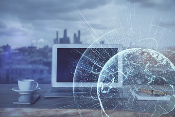 Computer on desktop with social network hologram. Multi exposure. Concept of international people connections.