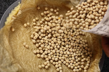 Adding baking beans in pastry case. Making Chocolate, Pear and Pecan Pie Series.