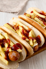 Homemade Cleveland Polish Boy Sandwich on a rustic wooden board on a white wooden surface, side view. Close-up.