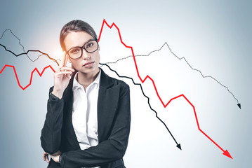 Thoughtful young businesswoman, falling graph