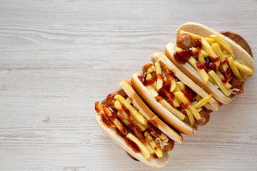 Homemade Cleveland Polish Boy Sandwich on a rustic wooden board on a white wooden background, top view. Flat lay, overhead, from above. Space for text.