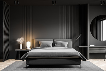 Gray bedroom interior with round mirror