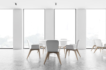 Loft white cafe interior with round tables