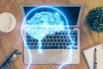 Multi exposure of work table with computer and brain hologram. Brainstorm concept.