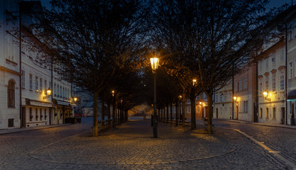 A quiet old cobbled square in Prague during the early morning