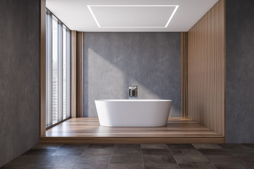 Obraz na płótnie Canvas Gray and dark wooden bathroom with tub