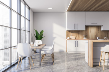 White and wooden kitchen with dining table